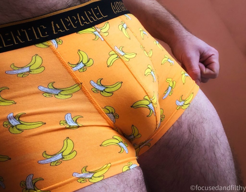 Colour close up photograph of a guy in some yellow pants (trunk style underwear) which are covered in pictures of bananas  